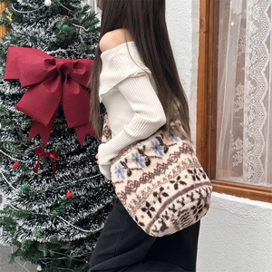 Winter plush bucket bag with Fair Isle pattern shown on shoulder in a festive setting