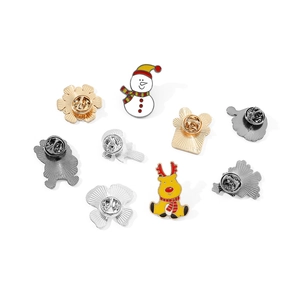 Detail of Christmas enamel pins set with snowman and elk designs on multiple metal bases
