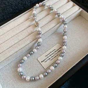 Elegant French-style tri-color pearl necklace with white, grey, and lilac beads and metal clasp