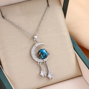 Elegant silver titanium necklace with crescent moon and blue star pendant in a gift box