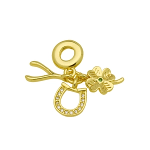 Macro detail of 18k gold plated charms featuring horseshoe, wishbone, and green lucky clover