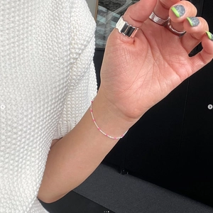 Elegant 925 sterling silver bead bracelet with pink accents on female model wrist