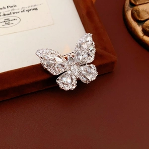 Detailed close-up of a silver butterfly brooch with marquise-cut sparkling zircon stones