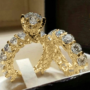 Luxurious yellow gold tone ring set with a large main zircon and pavé eternity band