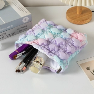 Close-up of a gradient cloud makeup bag with 3D bubble texture in purple pink and blue