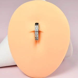 Macro shot of silver curved belly button ring with double rows of rectangular opals