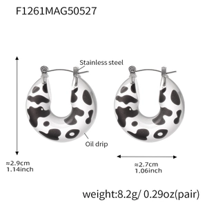 Detail of U-shaped resin hoop earrings with black and white cow pattern and steel pins