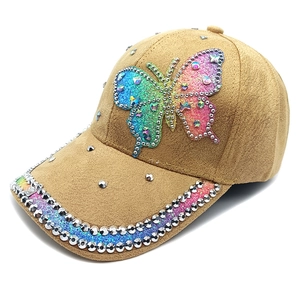 Detail of camel faux suede baseball cap with glitter butterfly patch and crystal studs