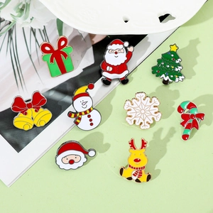 Close-up of alloy enamel Christmas brooches featuring Santa, reindeer, and snowman designs