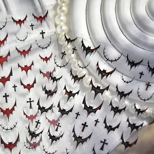 Gothic metal nail stickers featuring black bats and red crosses for Halloween manicure