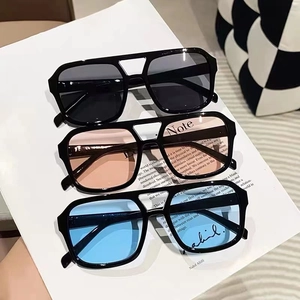 Detail showing square double-bridge sunglasses in black, pink, and blue lenses