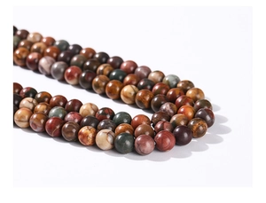 Macro shot of natural stone beads in earthy tones with a matte finish for jewelry DIY