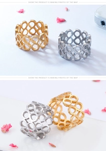 Close-up of gold and silver titanium rings with infinity cut-out design and crystals