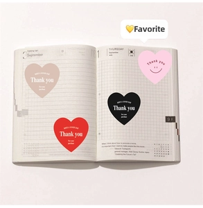 Detail of colorful heart stickers with Thank You text on a minimalist journal page