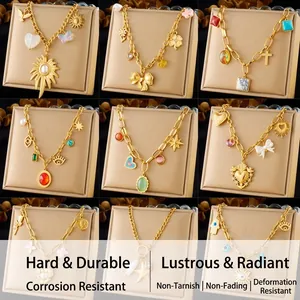 Collection of nine gold plated stainless steel necklaces with various vintage pendants