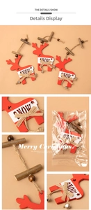 Detailed view of red wooden reindeer ornament with SNOW print and metal bell detail