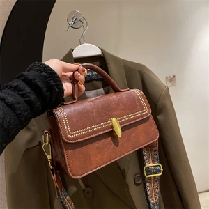 Vintage brown crossbody bag with gold rivets and bohemian print strap for women