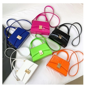 Crocodile pattern handbags in six colors with gold twist locks and braided handles