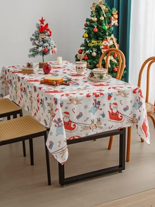 Nordic Christmas tablecloth with Santa and reindeer prints in a cozy holiday home setting