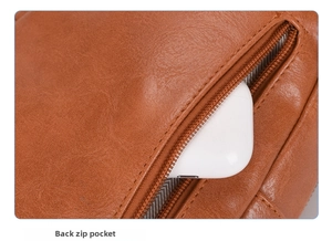 Detail of the back zip pocket on brown leather laptop bag with striped lining