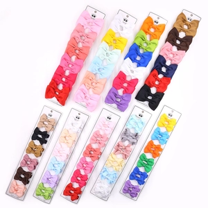 Close-up of assorted colorful ribbed ribbon bow hair clips on display cards