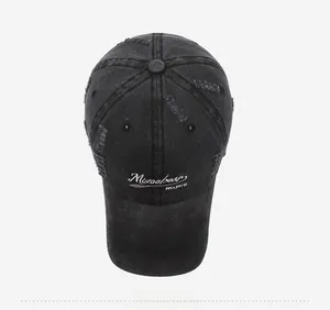 Close-up of distressed cotton baseball cap with vintage embroidery and worn texture
