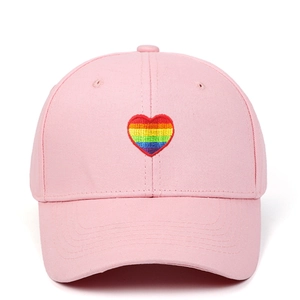 Pink cotton baseball cap featuring a vibrant rainbow heart embroidery on the front panel