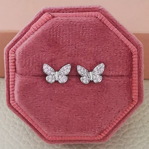 Elegant silver butterfly stud earrings with pink zircon in a velvet jewelry box