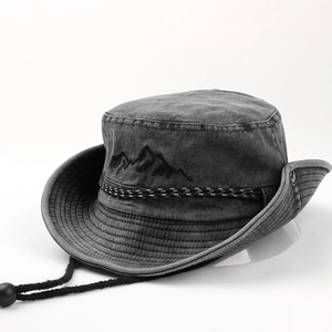 Detail of dark grey washed denim bucket hat with mountain embroidery and windproof cord