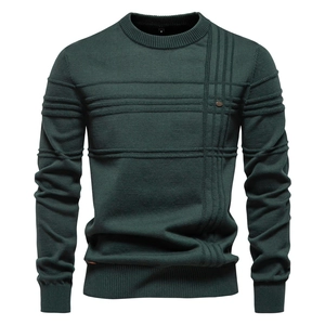 Macro shot of dark green knit sweater neck detail with M size tag and ribbed collar