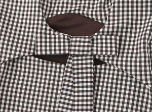 Detailed close-up of brown gingham fabric and knotted bow detail on a stretch top