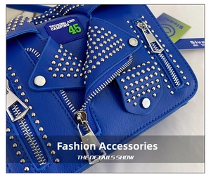 Detail of blue biker-style bag with jacket collar design, rivets and metal zippers