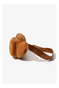 Detail view of brown corduroy waist bag showing dual zippers and nylon strap texture