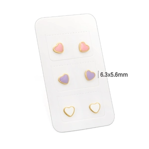 Three pairs of small colorful enamel heart stud earrings in pink, purple, and white tones