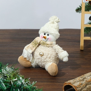 Detailed view of a plush Christmas snowman ornament with knit scarf and pearl button detail