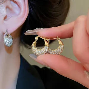 Elegant gold U-shaped hoop earrings featuring sparkling pave cubic zirconia crystals