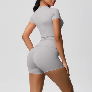 Detail view of grey high-stretch yoga set showing sleek fit on shorts and tee