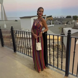 Detail of colorful vertical striped maxi dress with deep V-neck and halter back