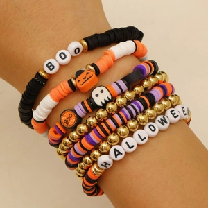 Detail of Halloween beaded bracelet set with polymer clay heishi beads and BOO charms