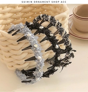 Detail of tweed braided headbands with pearls and rhinestones on a beige textured base