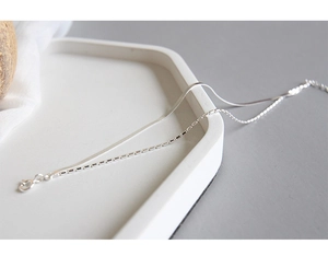 Close-up of minimalist double-layer S925 silver bracelet with snake and bead chains