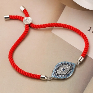 Classic red string bracelet with silver evil eye charm featuring blue and white zircons