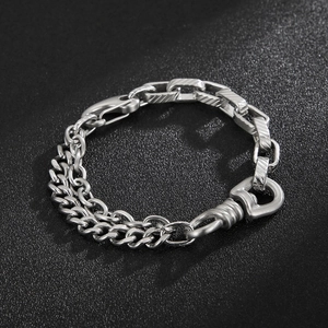 Detail of silver titanium steel bracelet with Cuban chain and textured rectangular links