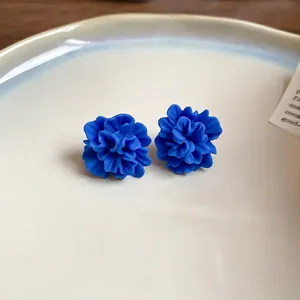 Blue resin flower earrings in a ceramic plate with elegant matte floral petal design