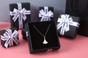 Luxury rose gold fan pendant necklace displayed with premium black litchi grain jewelry boxes