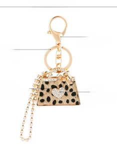 Detail of leopard print handbag keychain featuring rhinestone trim and polished alloy chain