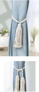 Detailed macro view of bohemian hand-woven cotton curtain tiebacks with tassels