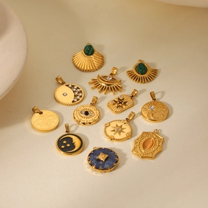 Detailed close-up of various gold-plated stainless steel star and moon pendant charms