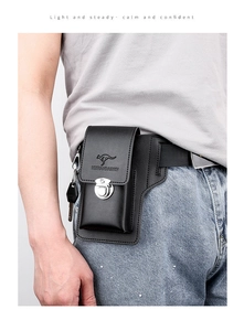 Detail of black leather waist bag with metal buckle and integrated key hook on belt