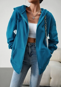 Detail view of a blue fleece hooded jacket with smooth zipper and front pockets